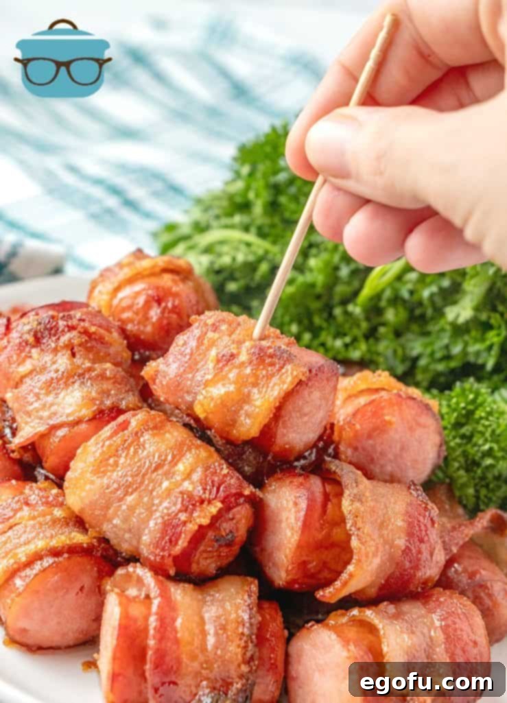 Crispy Bacon Brat Poppers 10 Bacon Wrapped Brats appetizer and party food on a white plate with toothpicks and a variety of mustards