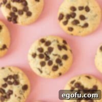 Square image of Chocolate Chip Cream Cheese Cookies on a pink background.