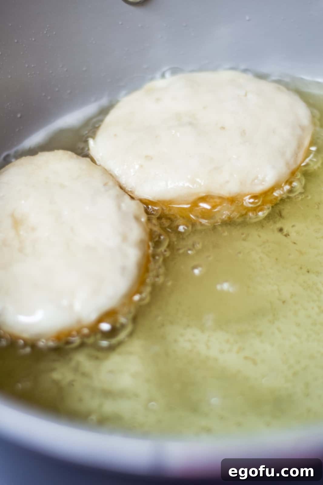 Biscuits placed into hot oil.