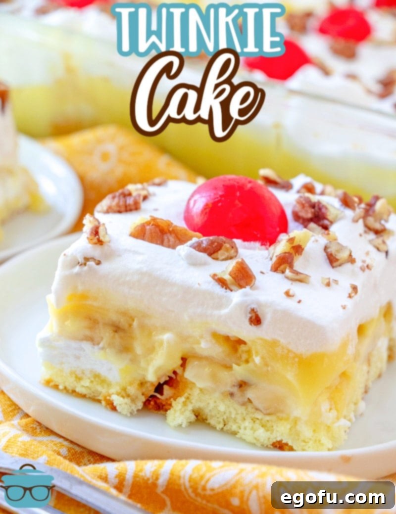 A close-up slice of No-Bake Twinkie Cake, showcasing the distinct layers of cake, bananas, pineapple, pudding, and whipped cream, garnished with a cherry.