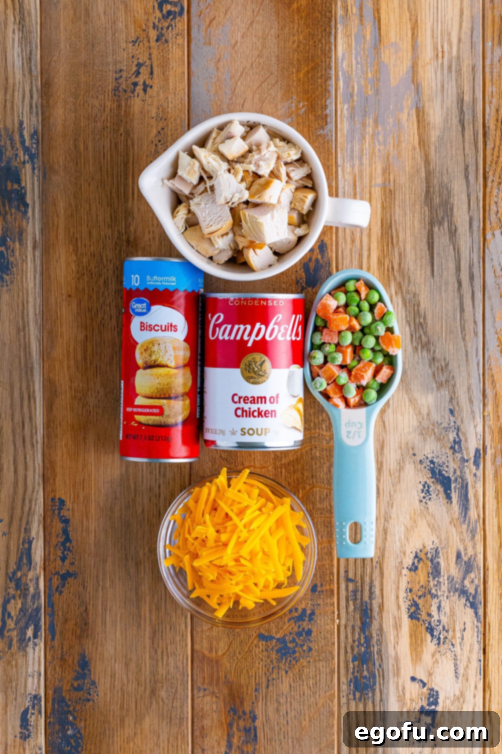 Shredded cheese, frozen vegetables, biscuit dough, cream of chicken soup and chicken.