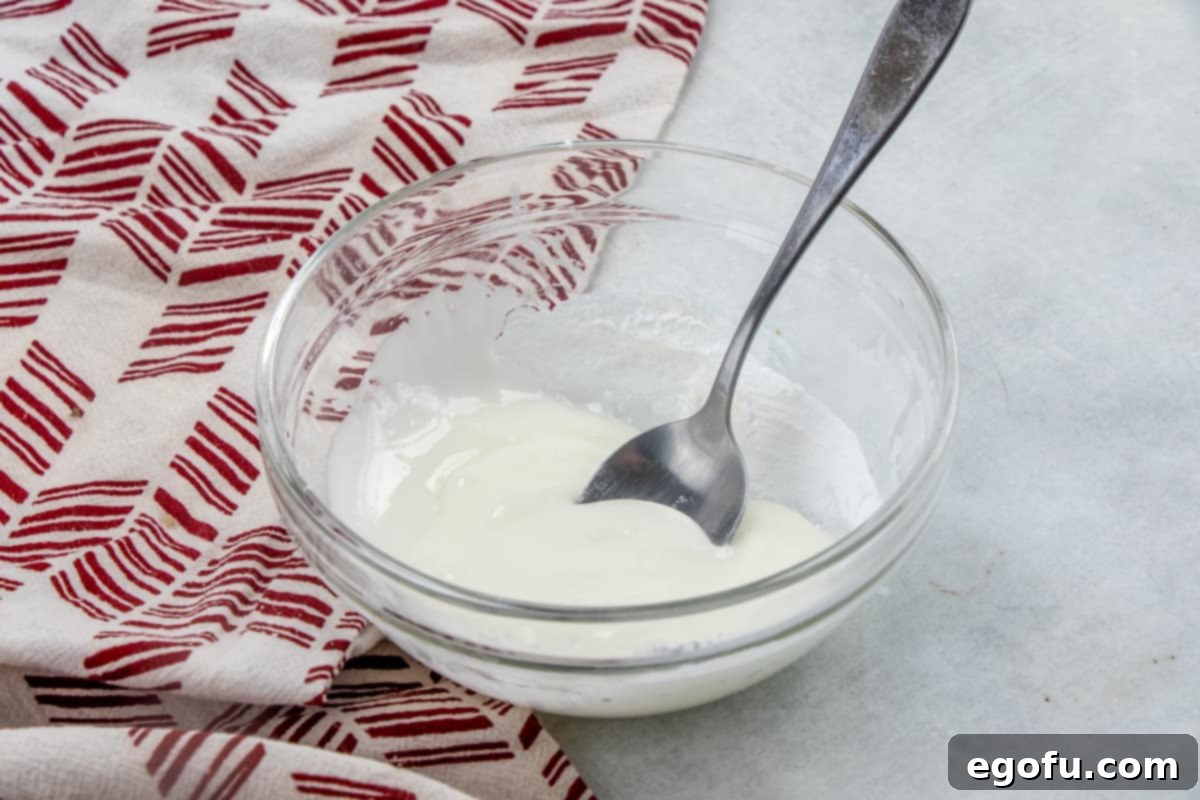 Powdered sugar and milk mixed together in a small bowl to create a sweet glaze, ready for drizzling.