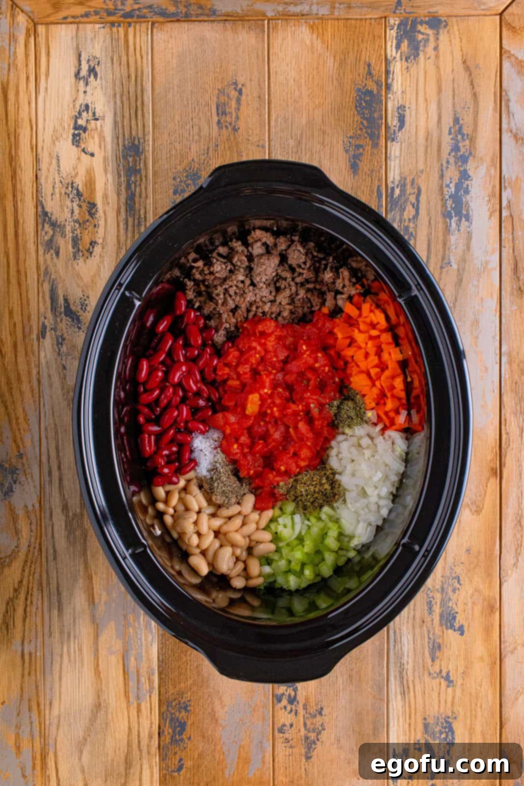 pasta e fagioli ingredients added to slow cooker. 
