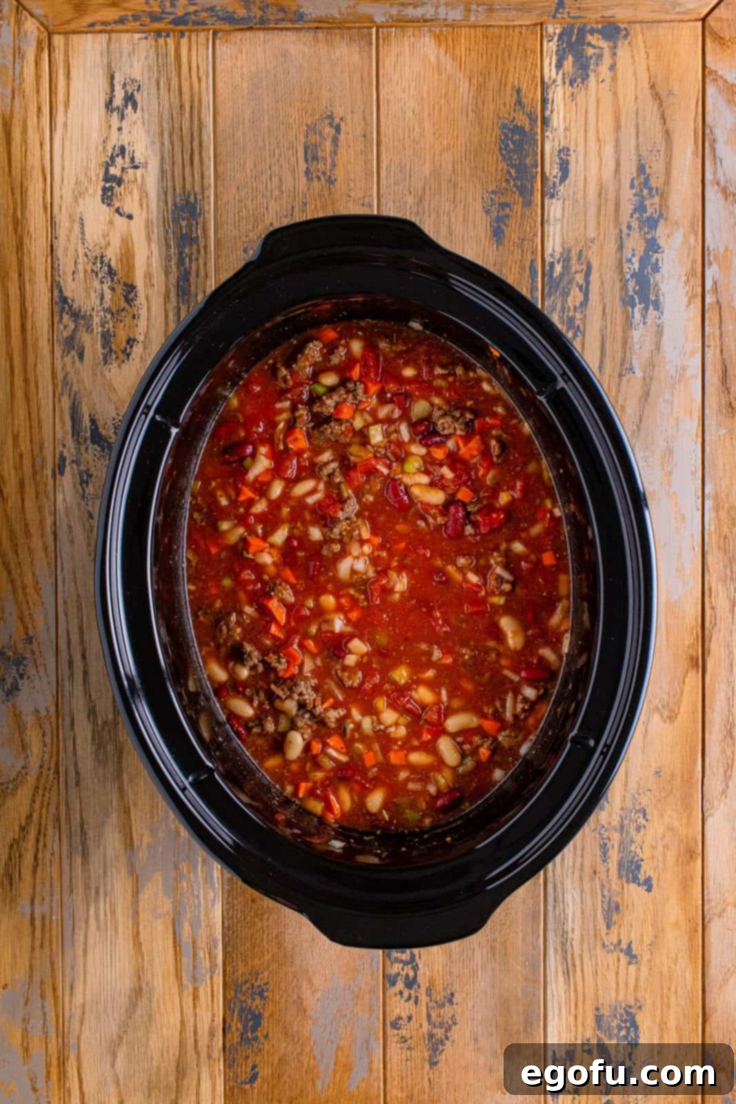 pasta e fagioli soup in an oval slow cooker.