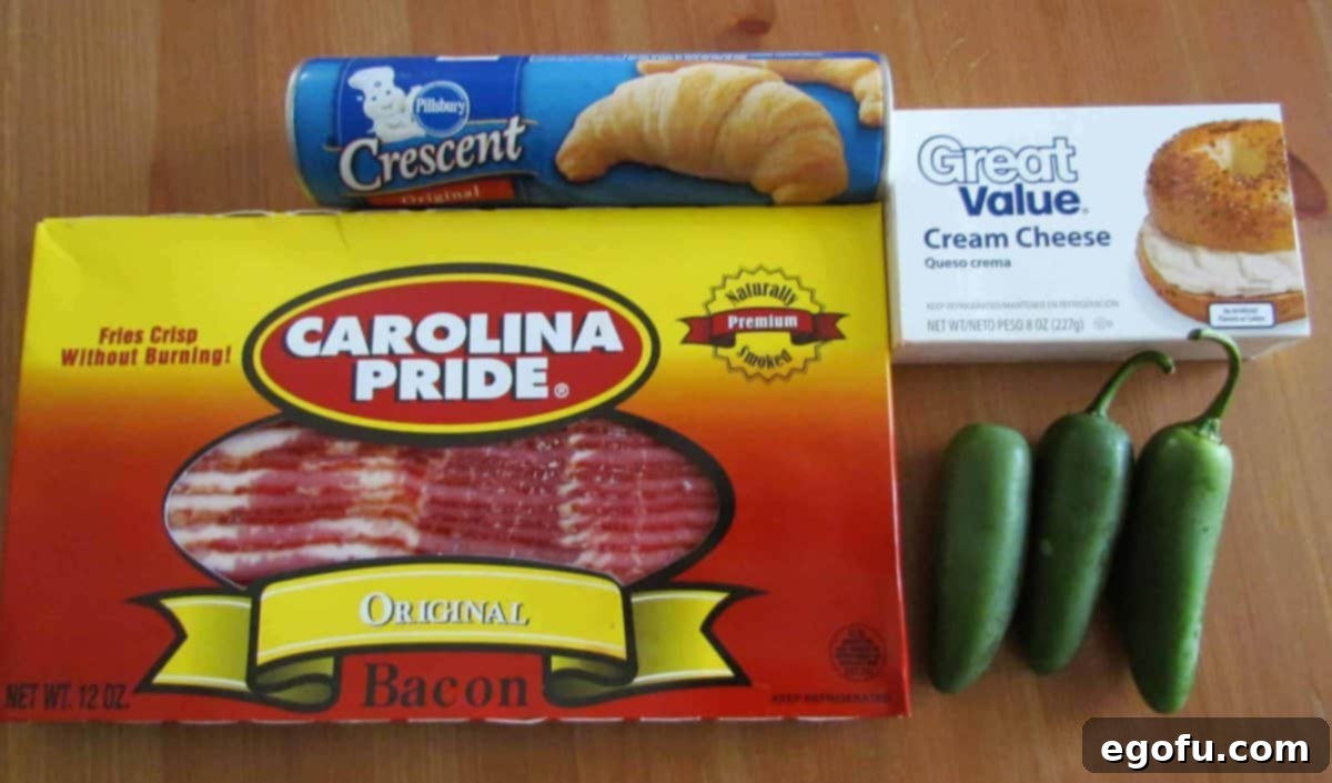 Zesty Jalapeño Delights 4 The essential ingredients laid out: fresh jalapeños, a tube of crescent rolls, cream cheese, and uncooked bacon strips, ready for preparation.