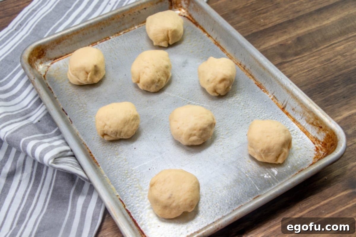 Zesty Jalapeño Delights 9 A baking sheet filled with unbaked crescent roll popper bites, neatly arranged and ready for the oven.