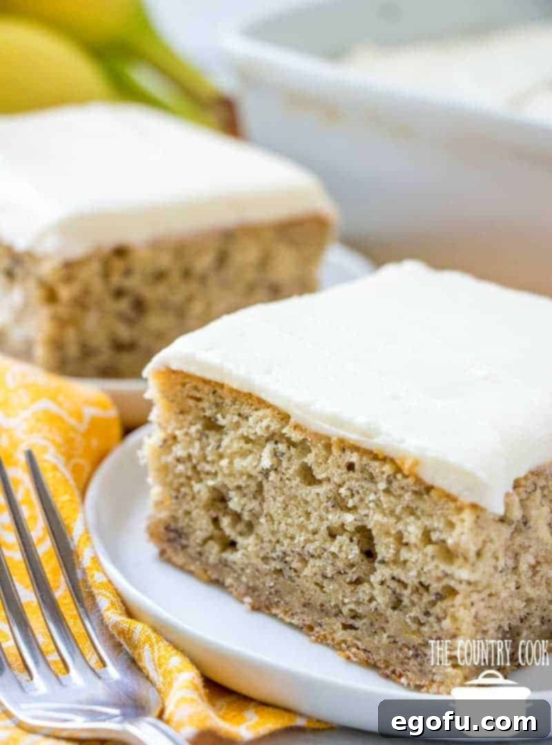 Two enticing slices of homemade banana cake, generously topped with fluffy vanilla frosting, rest on small, elegant round plates, inviting a taste.