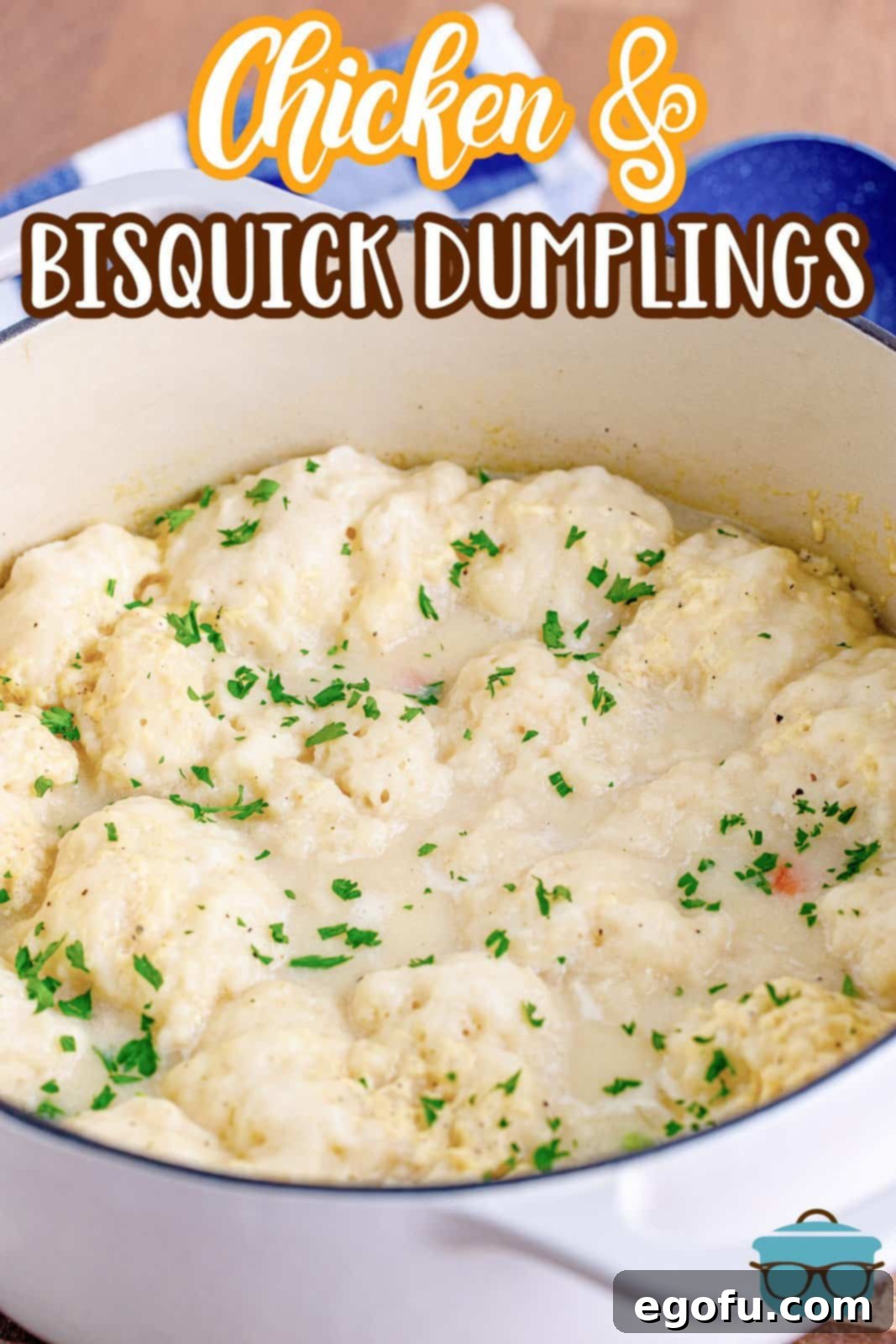 a large white pot of Chicken and Bisquick dumplings with dried parsley sprinkled on top. 