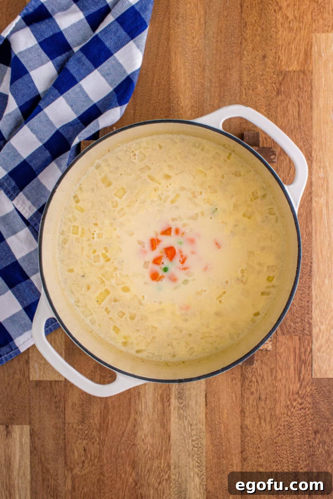 peas and carrots added to the pot. 