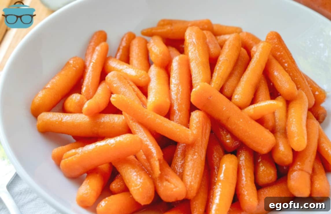 Maple Kissed Carrots 2 Perfectly cooked Maple Glazed Carrots, glistening with a rich glaze, served in a pristine white bowl, ready to be enjoyed as a wholesome side.
