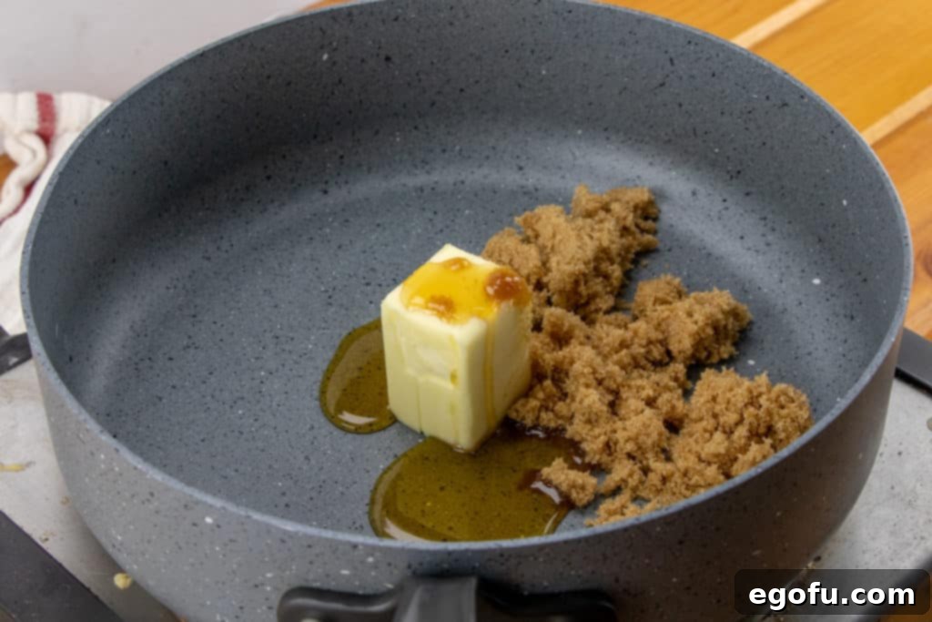 Maple Kissed Carrots 5 A close-up view of light brown sugar, golden butter, and rich maple syrup melting together in a large skillet, swirling to form the base of the sweet, aromatic glaze.