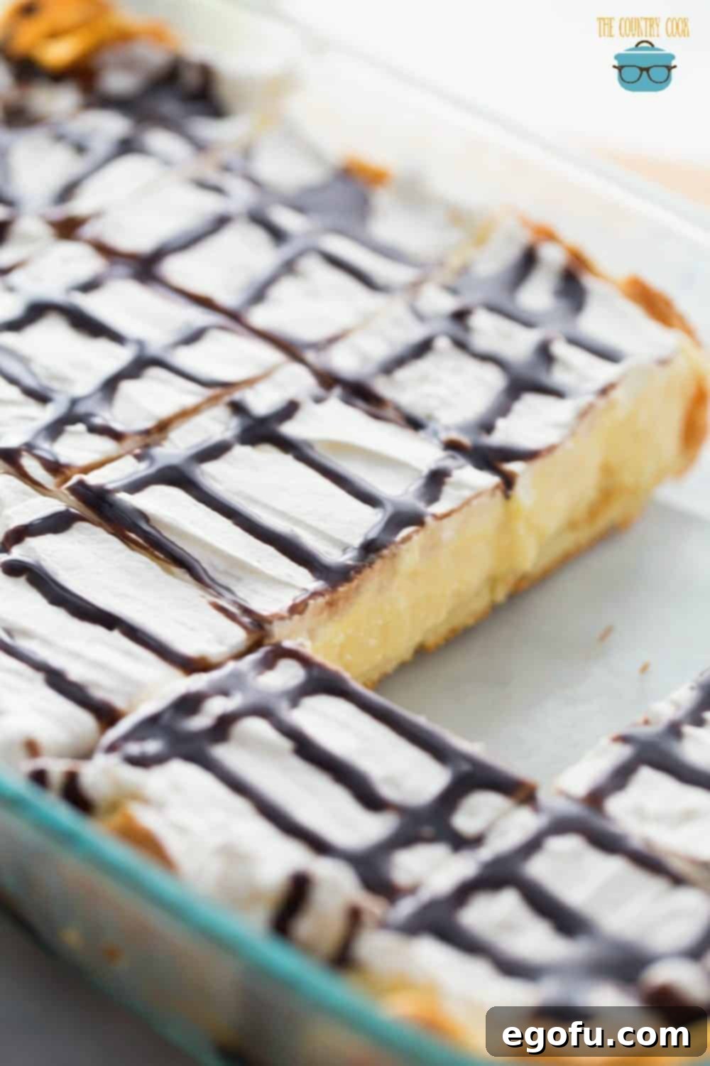 Cream Puff Dessert in a baking dish with two slices removed, ready for enjoyment.