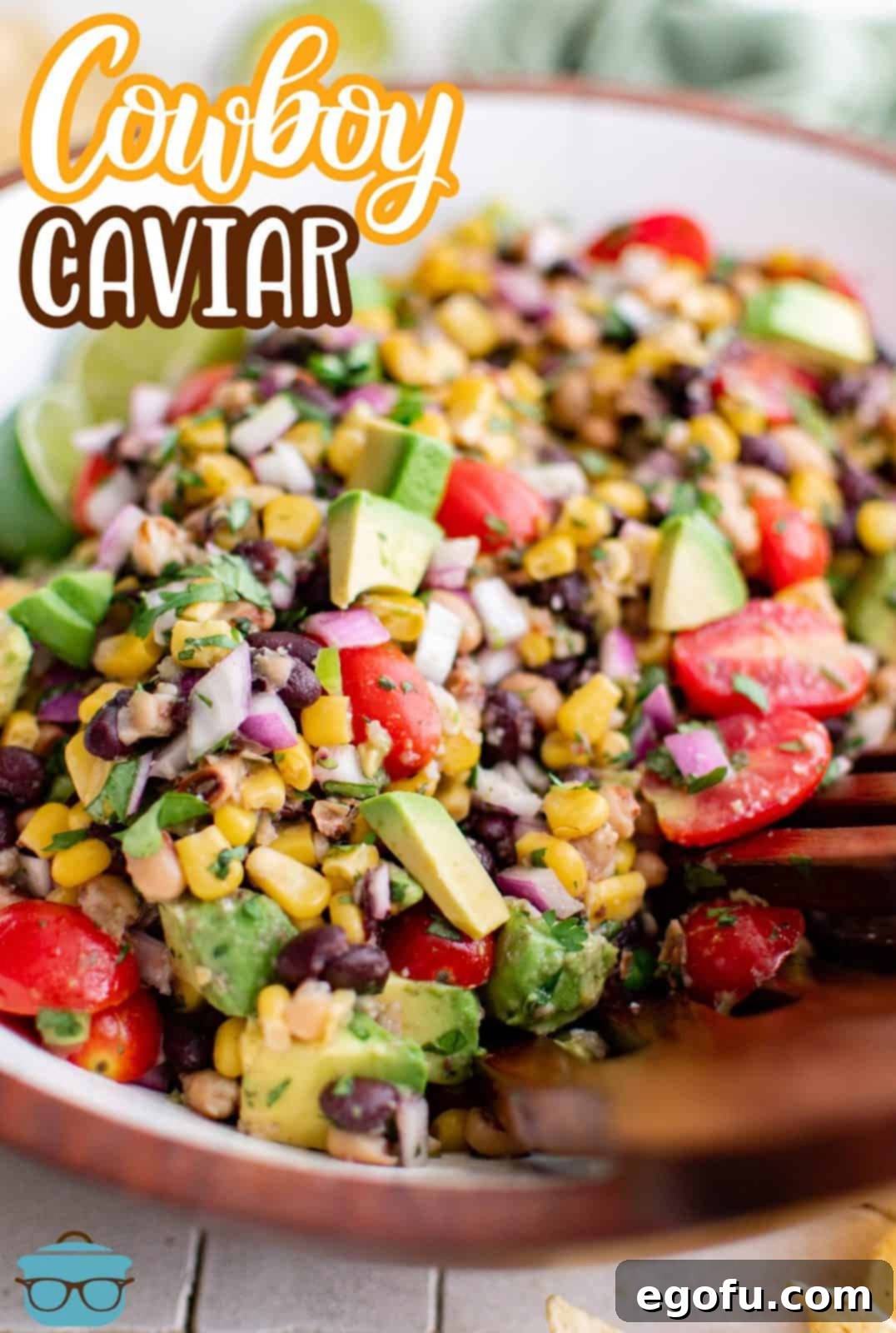 Western Whimsey Dip 3 Delicious Cowboy Caviar artfully arranged on a wooden plate, ready for serving. This image is also suitable for Pinterest.