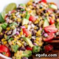 Western Whimsey Dip 6 Close up of vibrant Cowboy Caviar on a wooden plate, garnished with fresh cilantro.