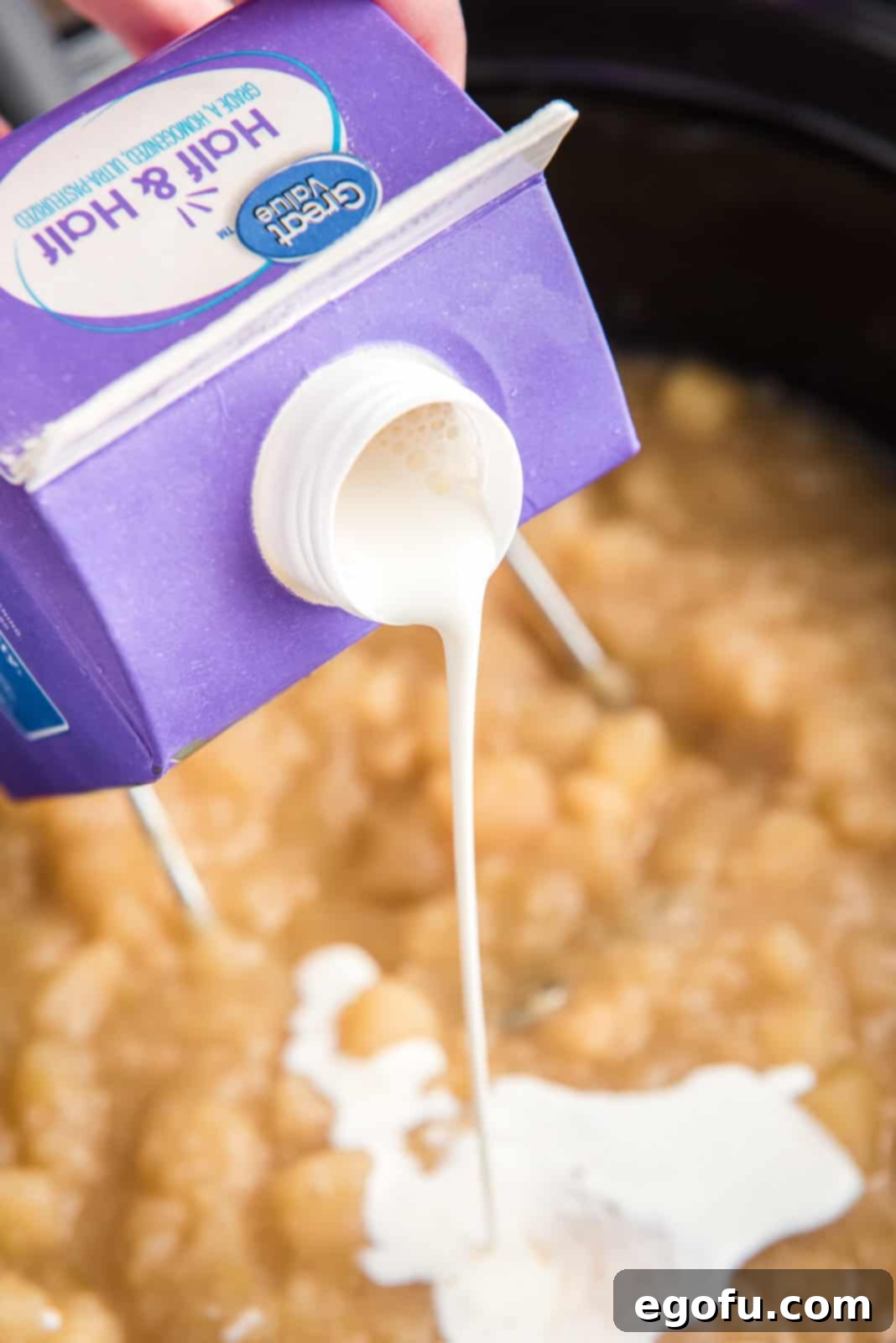 Slow Cooker Creamy Potato Bliss 8 Half and half is poured into the warm, mashed potato soup in the slow cooker, stirring in the final touch of creamy richness.