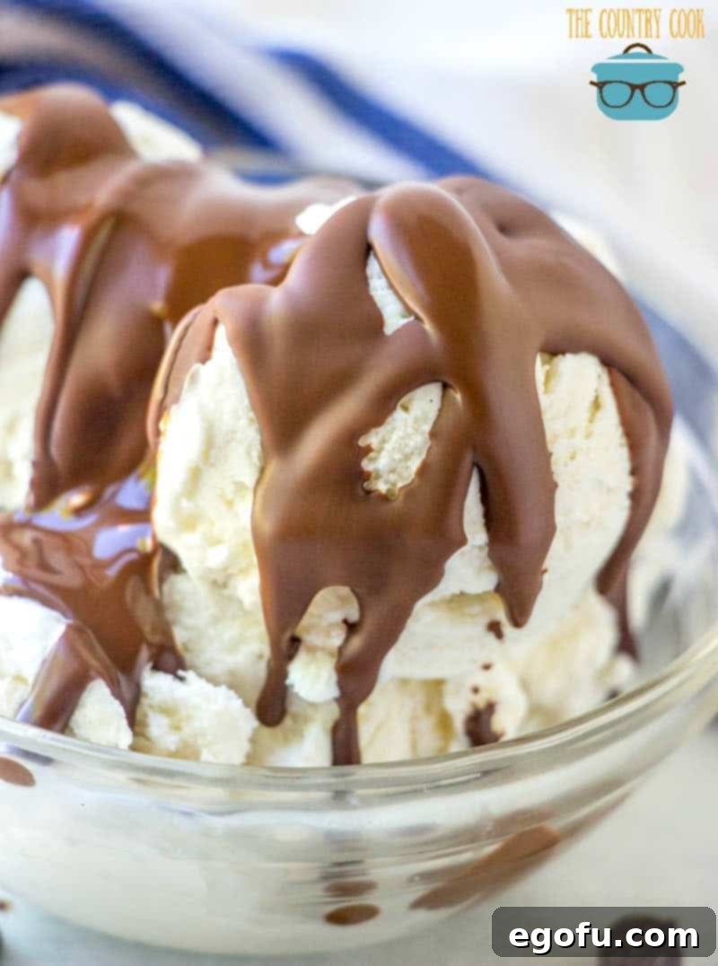 chocolate magic shell drizzled over vanilla ice cream in a small clear bowl.
