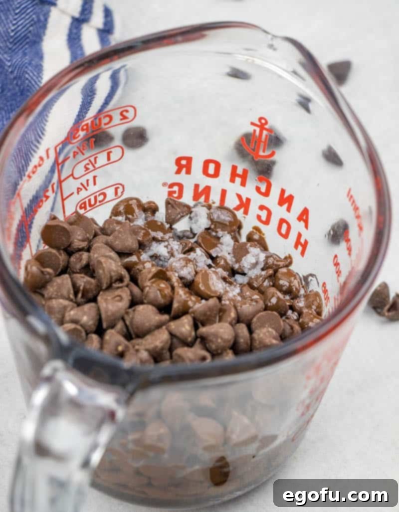 microwaved chocolate and coconut oil, softened, in a clear measuring cup.