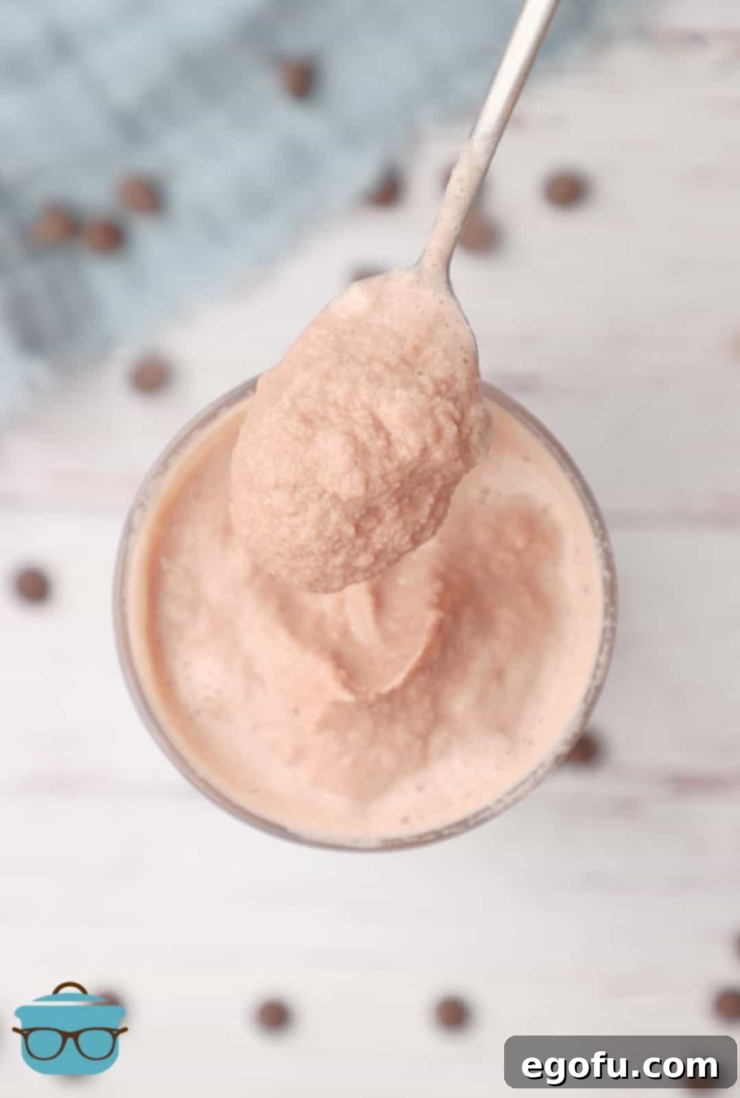 Wendys Creamy Frosty Delight 7 overhead photo of a spoon holding some Wendy's chocolate Frosty over a glass.