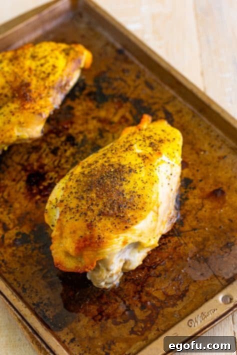 Chicken breast on a baking sheet.