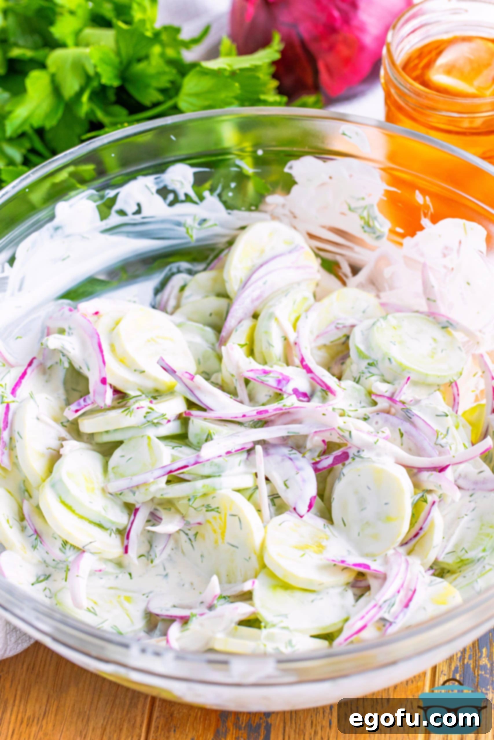 Chilled Cucumber Delight 2 A beautiful glass bowl filled with vibrant Creamy Cucumber Salad, ready to be served.