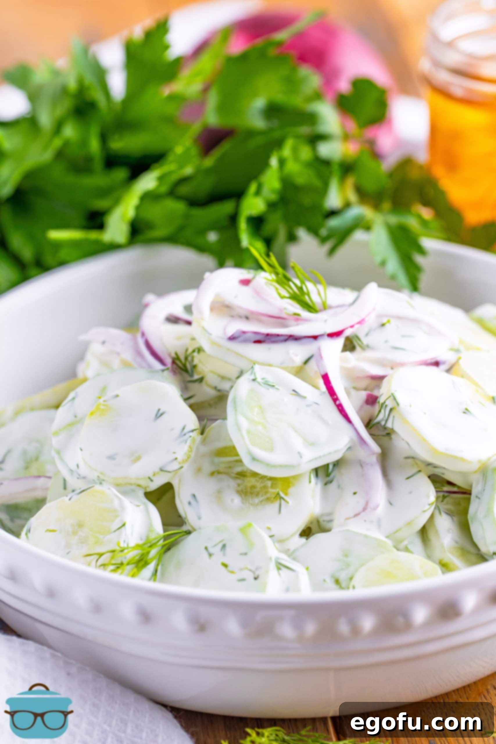 Chilled Cucumber Delight 8 A beautifully presented bowl of Creamy Cucumber Salad, garnished with a sprig of fresh dill, ready for serving.