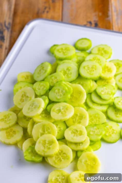Chilled Cucumber Delight 10 Sliced cucumbers on a cutting board, ready for the salad.