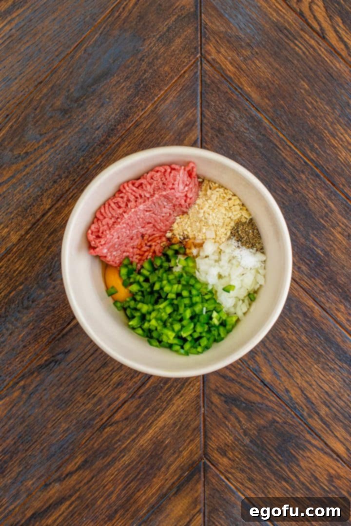 hamburger steaks ingredients in a white bowl.