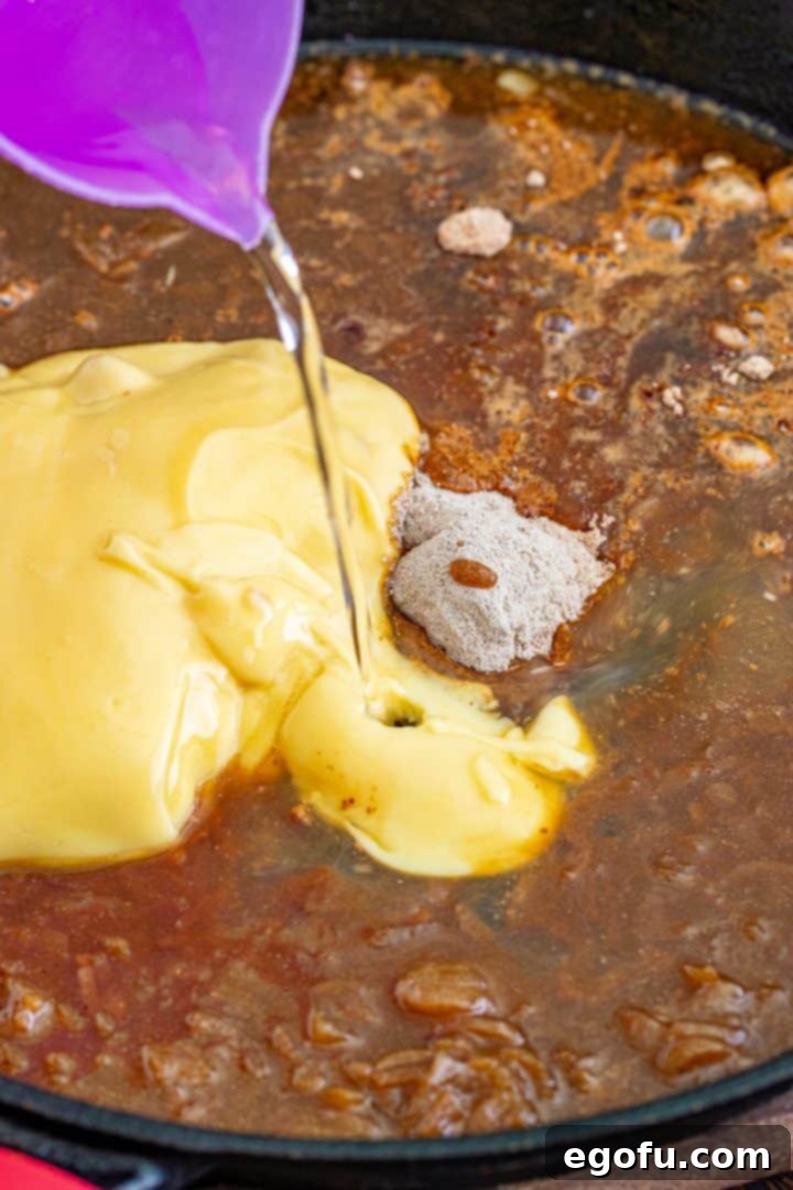 pouring water into a skillet with brown gravy mix, French Onion soup and cream of chicken soup.