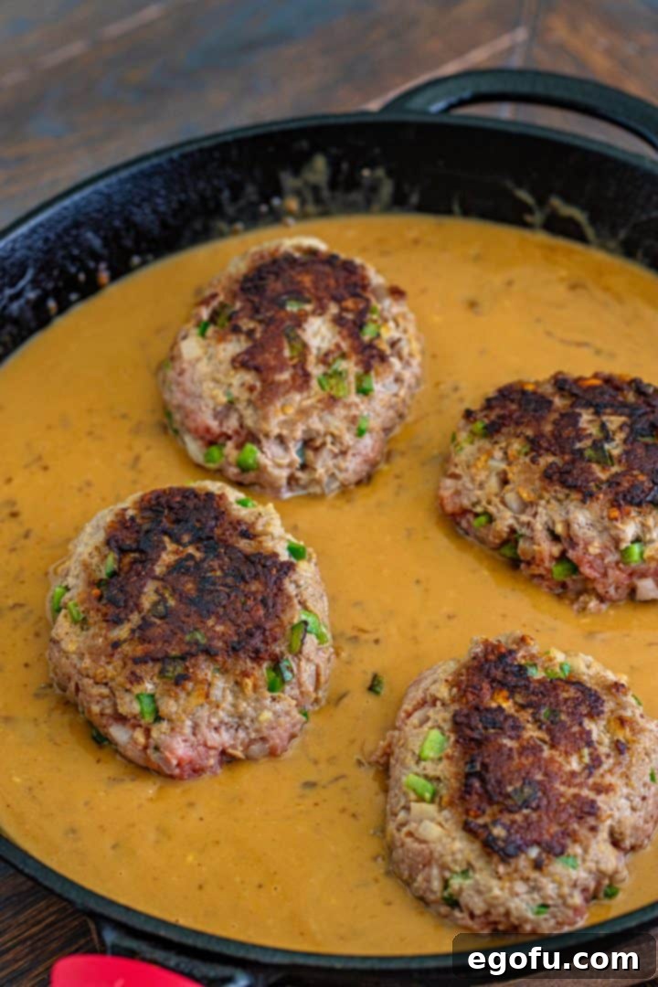 browned hamburger patties back into gravyy mixture in a cast iron skillet. 