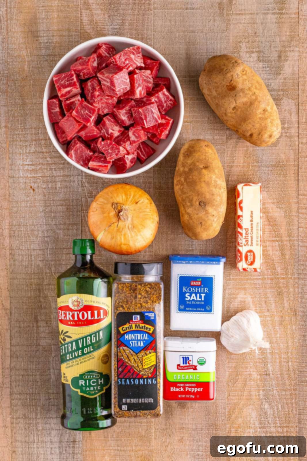 steak chunks, olive oil, onion, russet potatoes, garlic, salted butter, salt and pepper, steak seasoning.