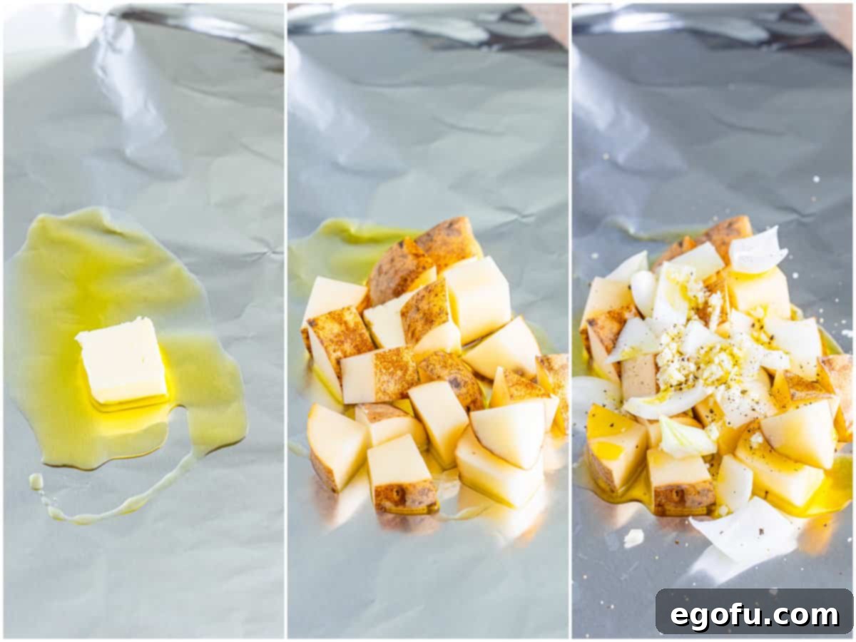 Diced potatoes, onions, and garlic seasoned and drizzled with olive oil on foil.