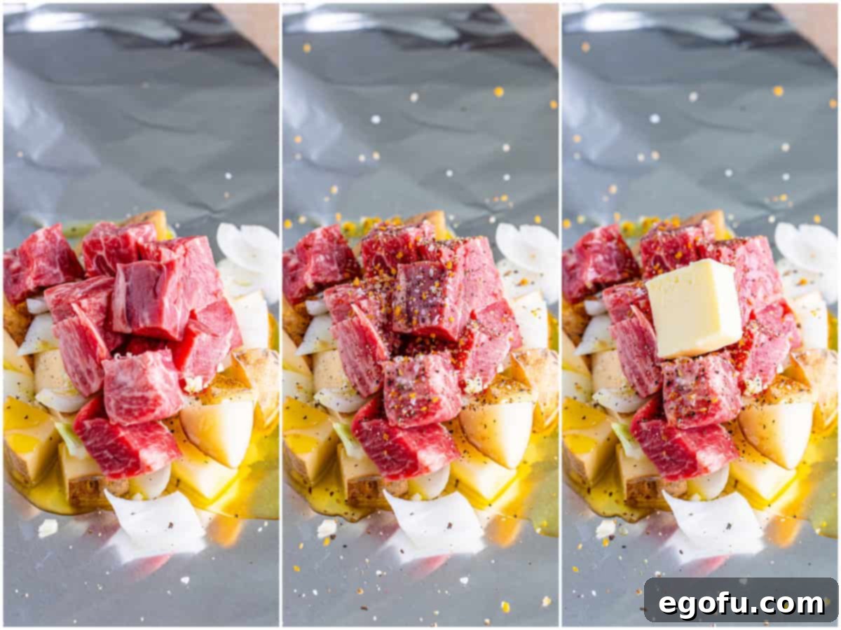 Cubed steak, seasoned, with butter and an ice cube on top, ready to be sealed in a foil packet.