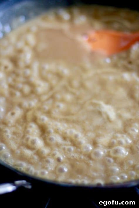 beef broth added to roux, heat turned to high to thicken