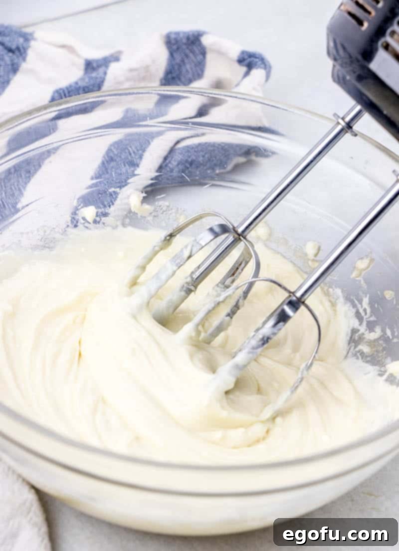 Effortless Cheesy Danishes 5 cheesecake cream cheese filling batter in a clear bowl.