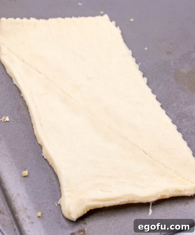 Effortless Cheesy Danishes 6 sealing perforations of crescent roll dough.