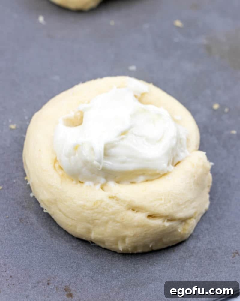 Effortless Cheesy Danishes 10 prepared crescent roll cheese danish on a baking sheet.