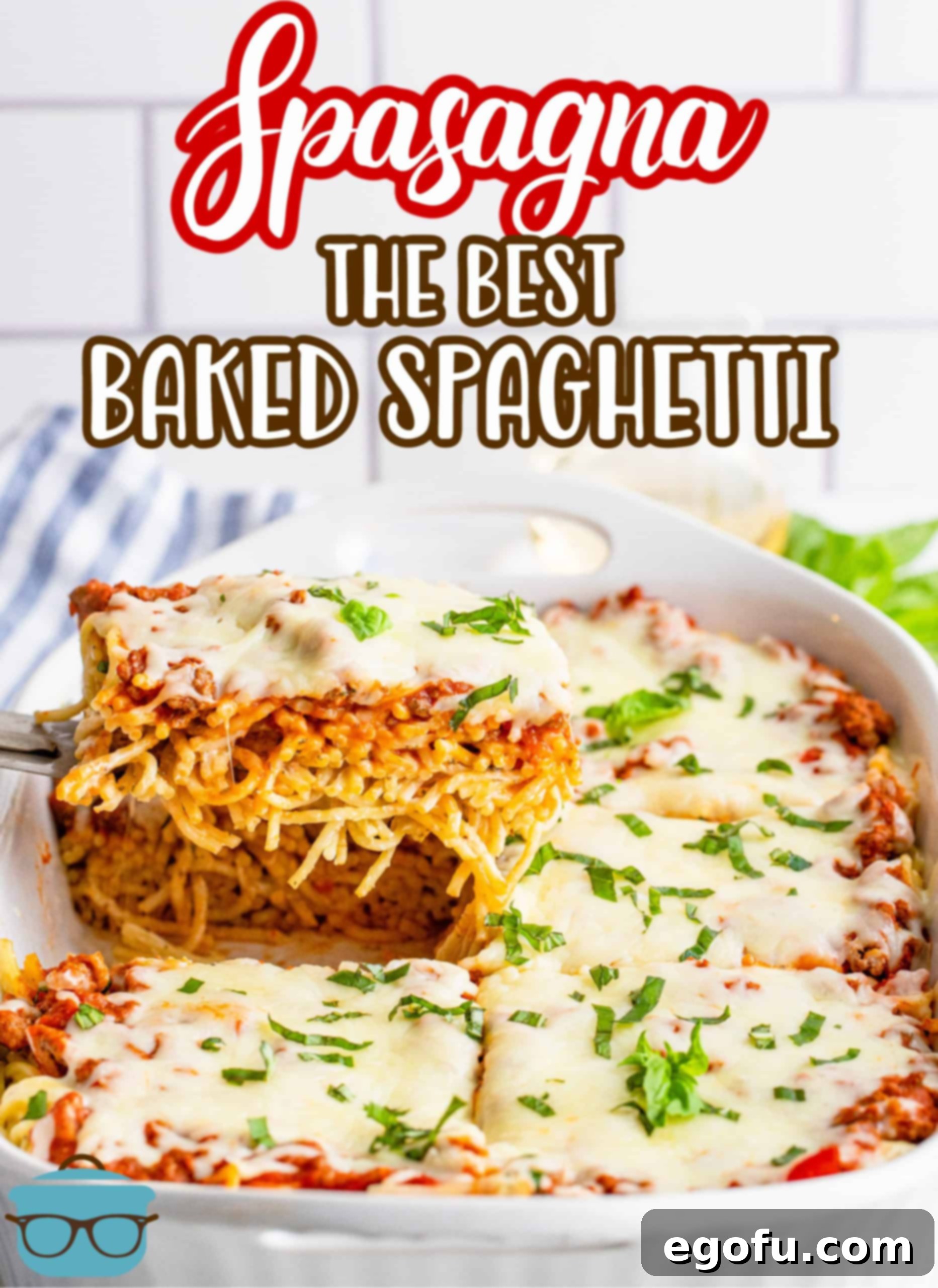 A serving of The Best Baked Spaghetti recipe, also known as Spasagna, being lifted out of the casserole dish with a spatula, showing the layers.