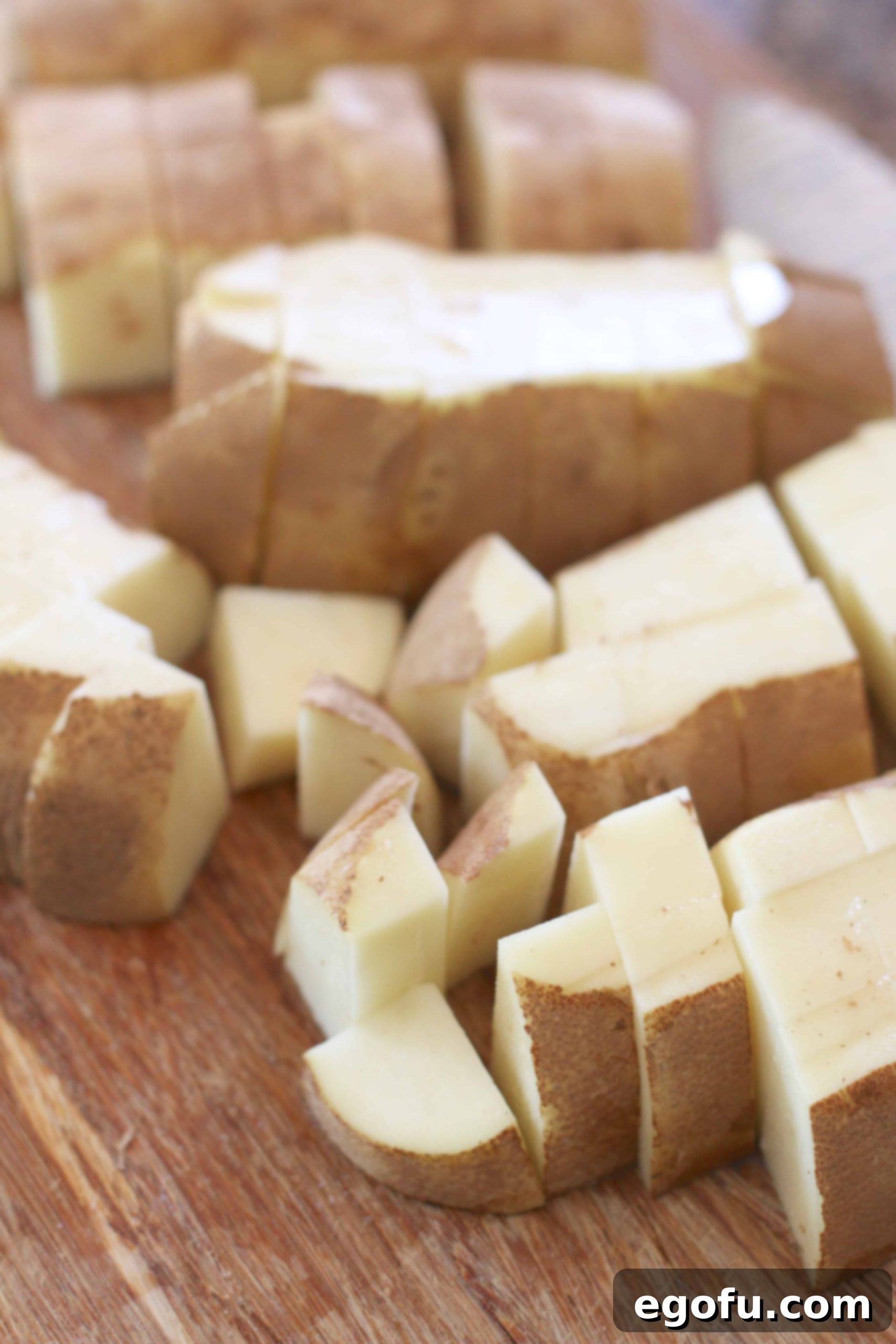 diced russet potatoes on a cutting board.
