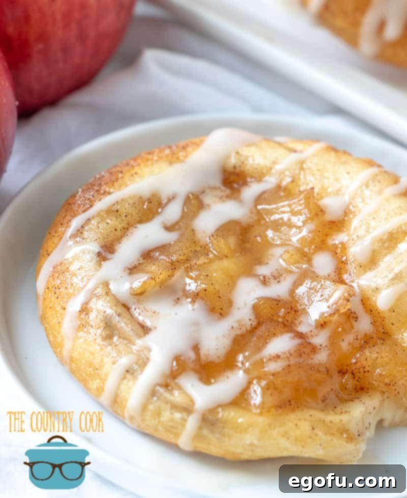 Golden Apple Danish Pastries 11 One apple crescent danish fully baked with a sweet glaze drizzled on top, ready to eat.