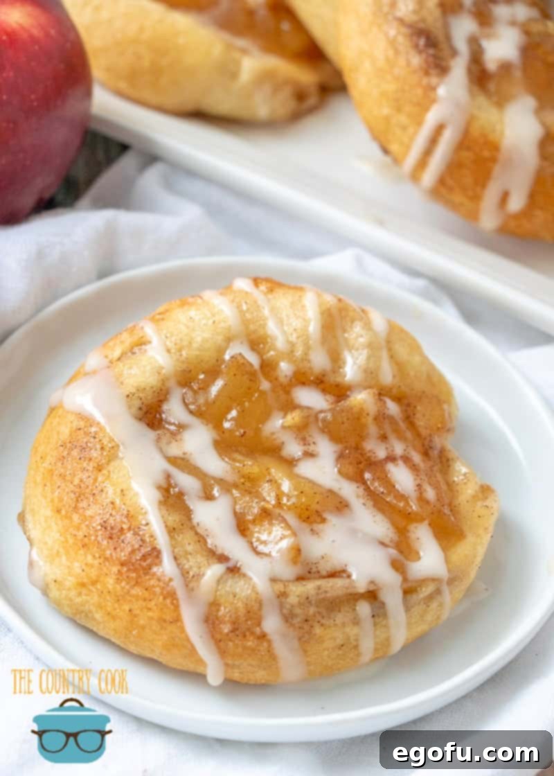 Golden Apple Danish Pastries 12 Apple Danish made with crescent rolls shown on a small round white plate, ready to be served.