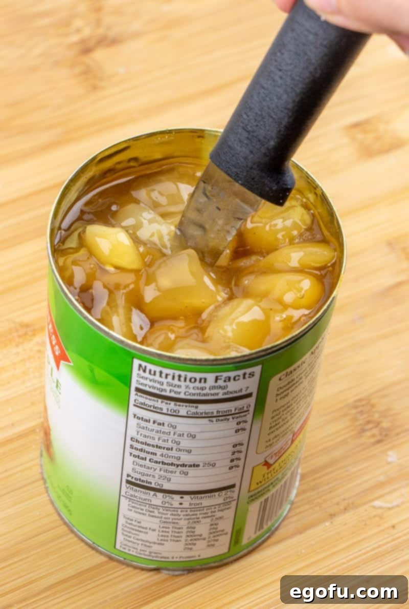 Golden Apple Danish Pastries 9 Chopped apple pie filling directly in the can with a knife, ready for use.