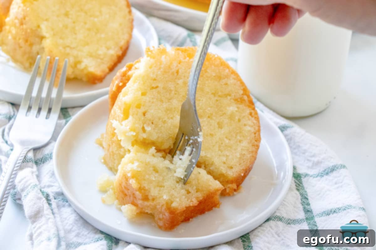 Kentucky Butter Cake 2 A slice of Kentucky Butter Cake with a fork, showing its moist texture.