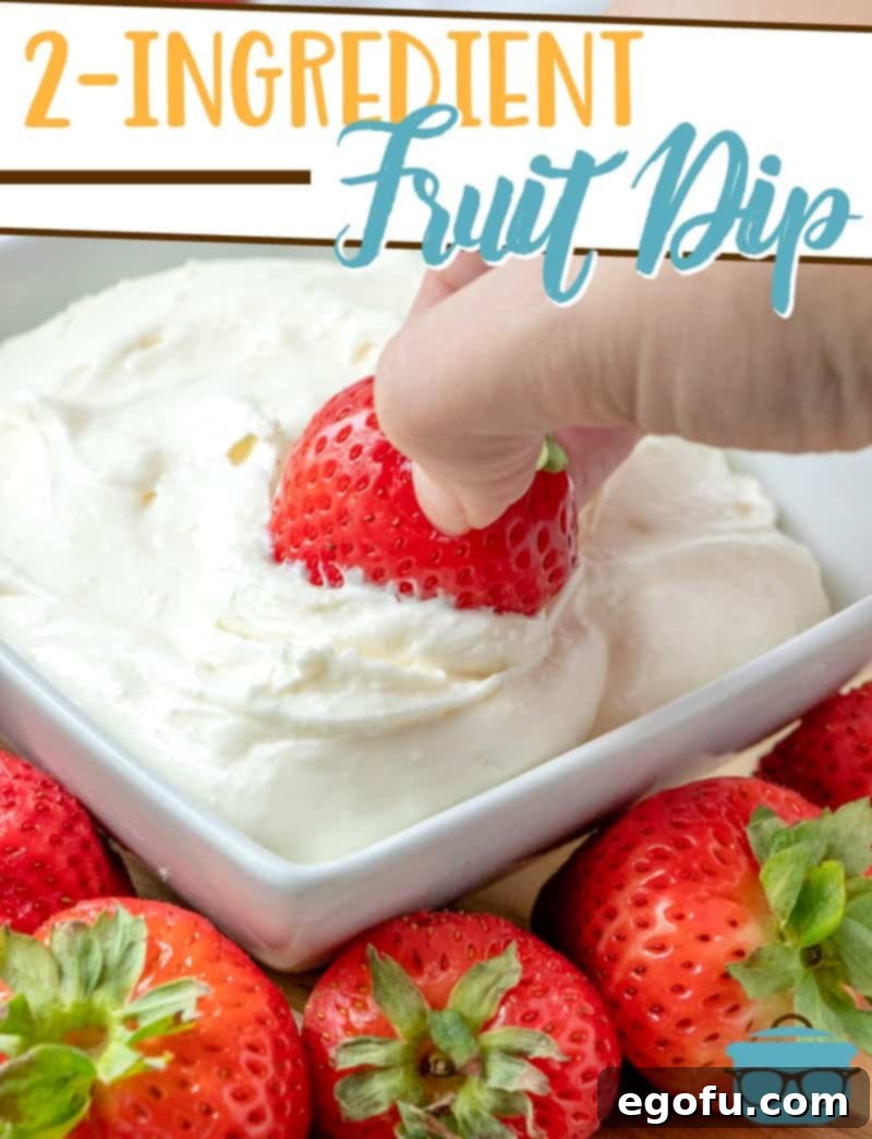 Close-up shot of a strawberry being dipped into a bowl of smooth, creamy white fruit dip, showcasing its perfect texture, with fresh strawberries scattered around.