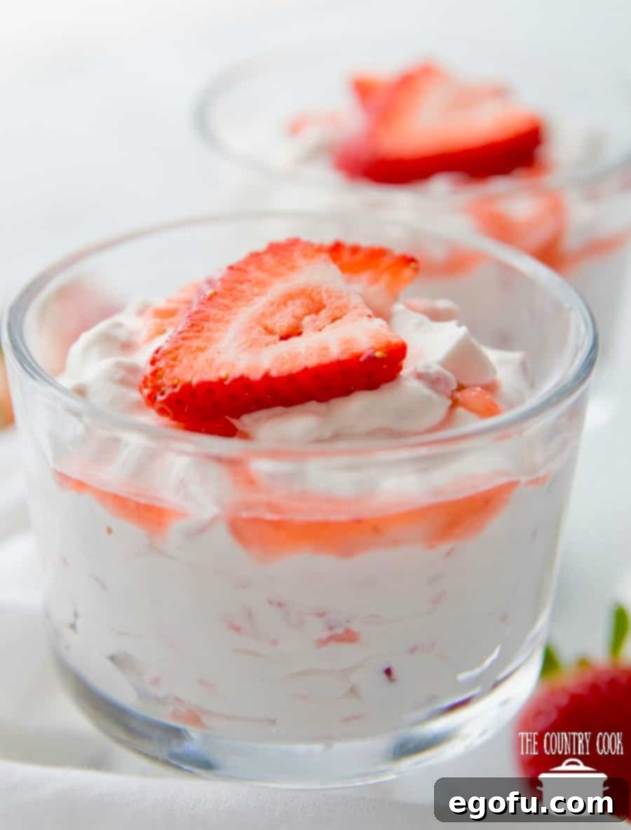 Strawberry Mess in a clear serving bowl garnished with fresh strawberries.