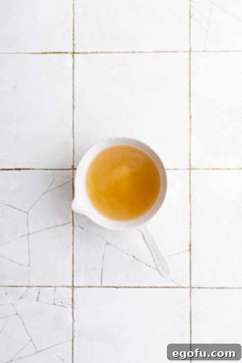 Chicken broth, honey, apple cider vinegar, garlic and salt whisked together in bowl.