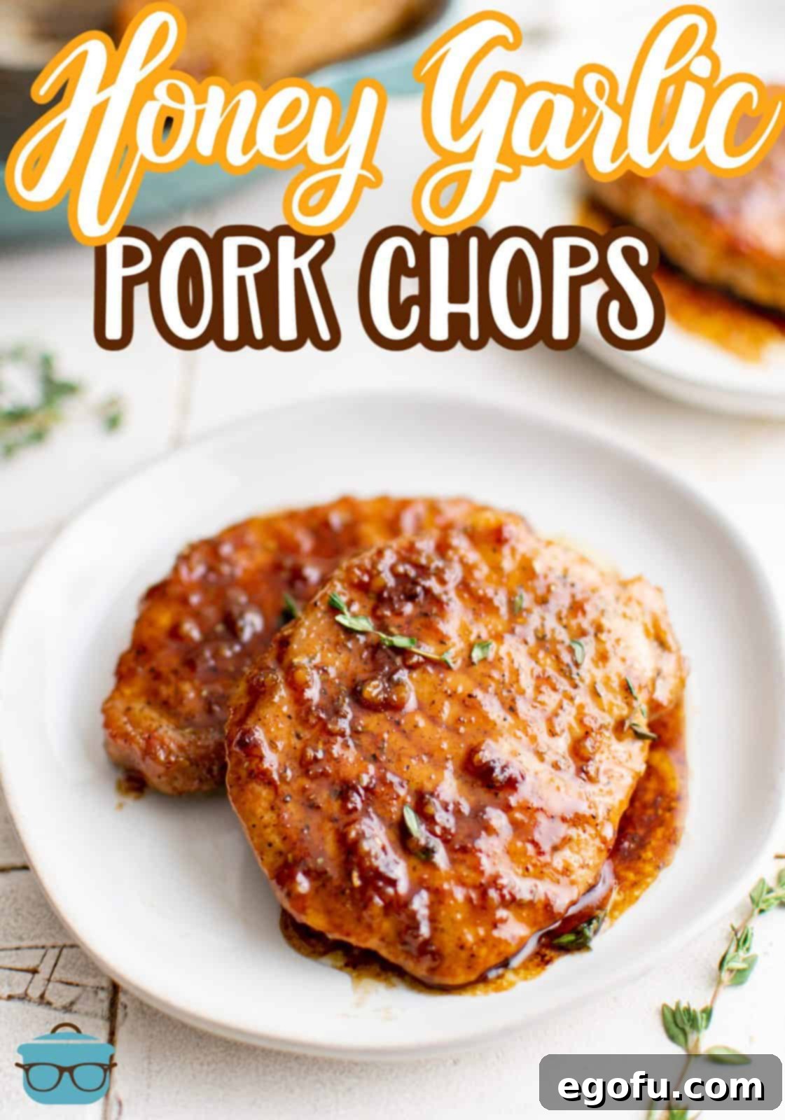 Two Honey Garlic Pork Chops on plate with glaze Pinterest image.