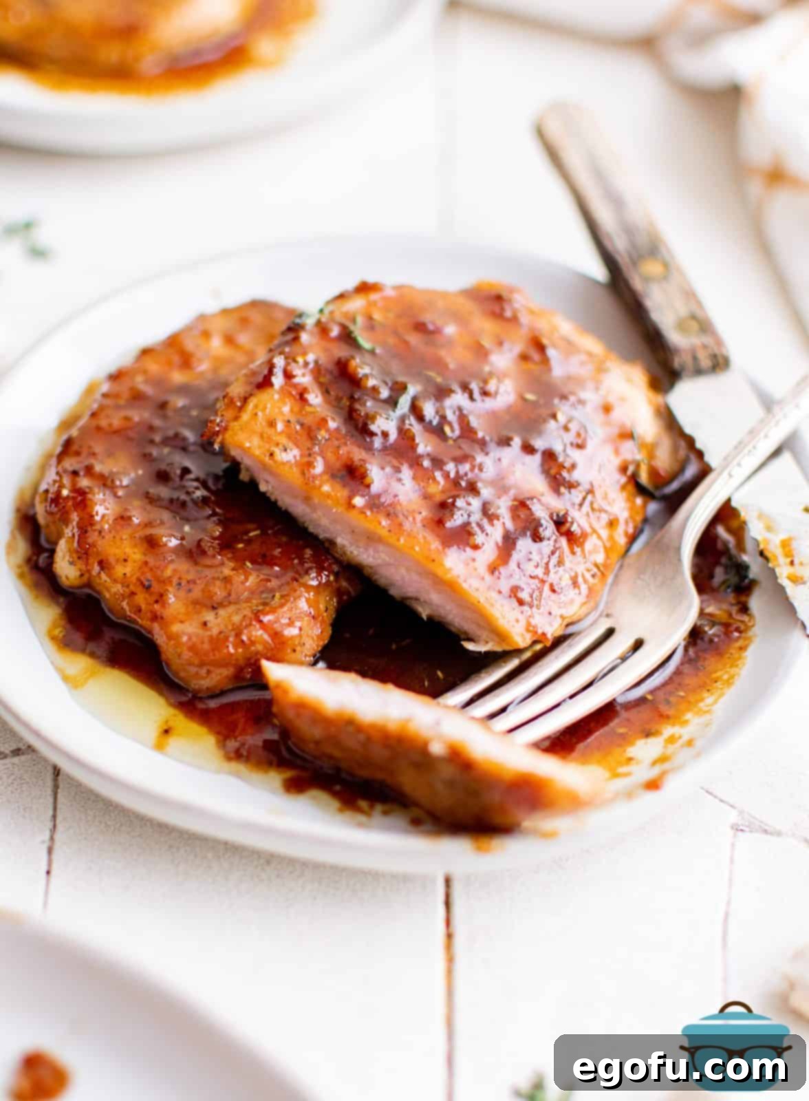 Honey Garlic Pork Chops on plate with slice cut out of one.