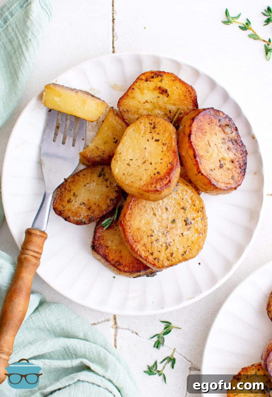 Golden Melt-Away Potatoes 2 Overhead of Melting Potatoes on white plate with one potato on fork.