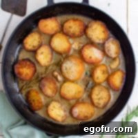 Golden Melt-Away Potatoes 9 Square image overhead of finished and garnished Melting Potatoes.