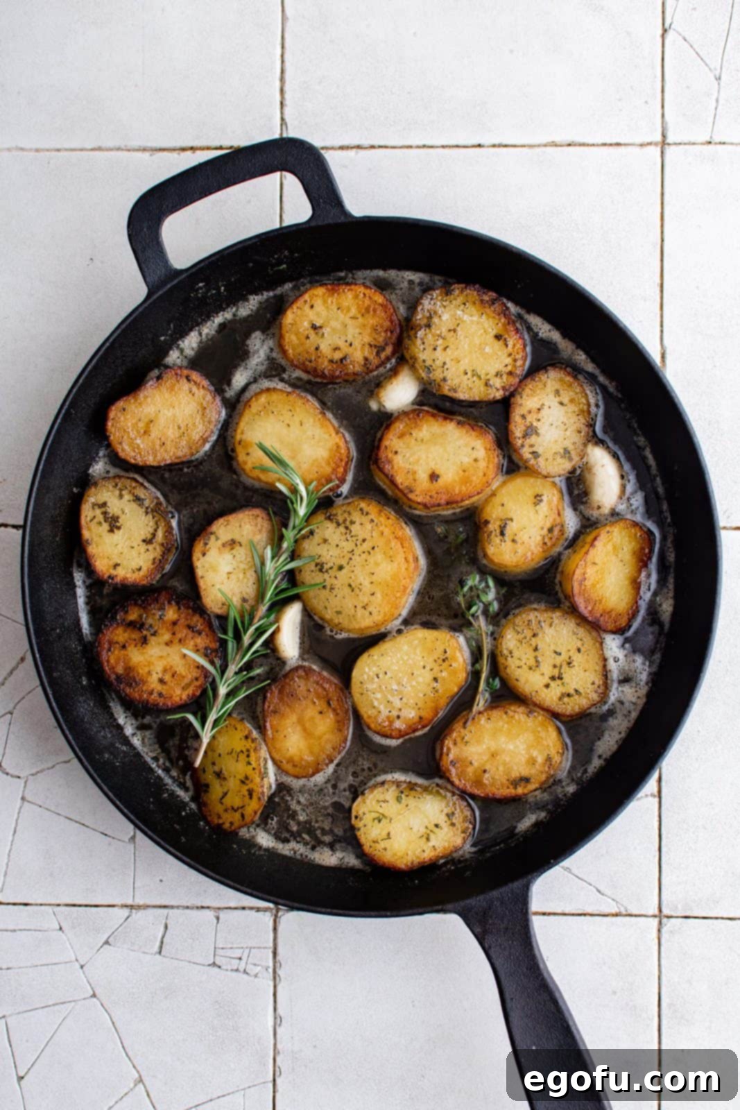 Golden Melt-Away Potatoes 5 Potatoes flipped over with garlic, rosemary, thyme and chicken broth added.